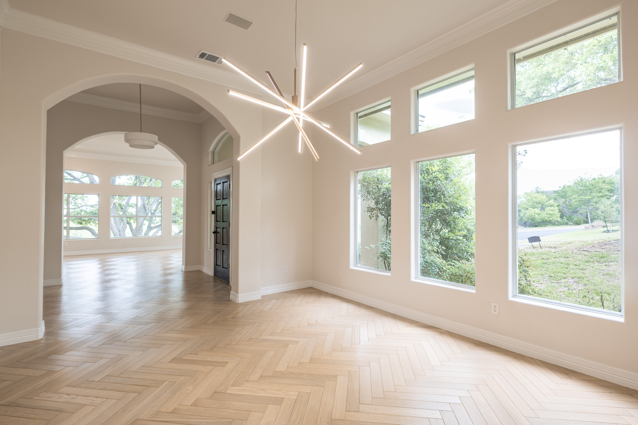 2906 Mill Reef Cove Austin, TX 78746 - Photo 20 of 38 a view of an empty room with a window and wooden floor