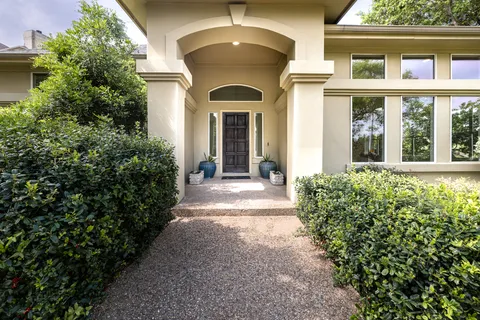 a view of a house with potted plants