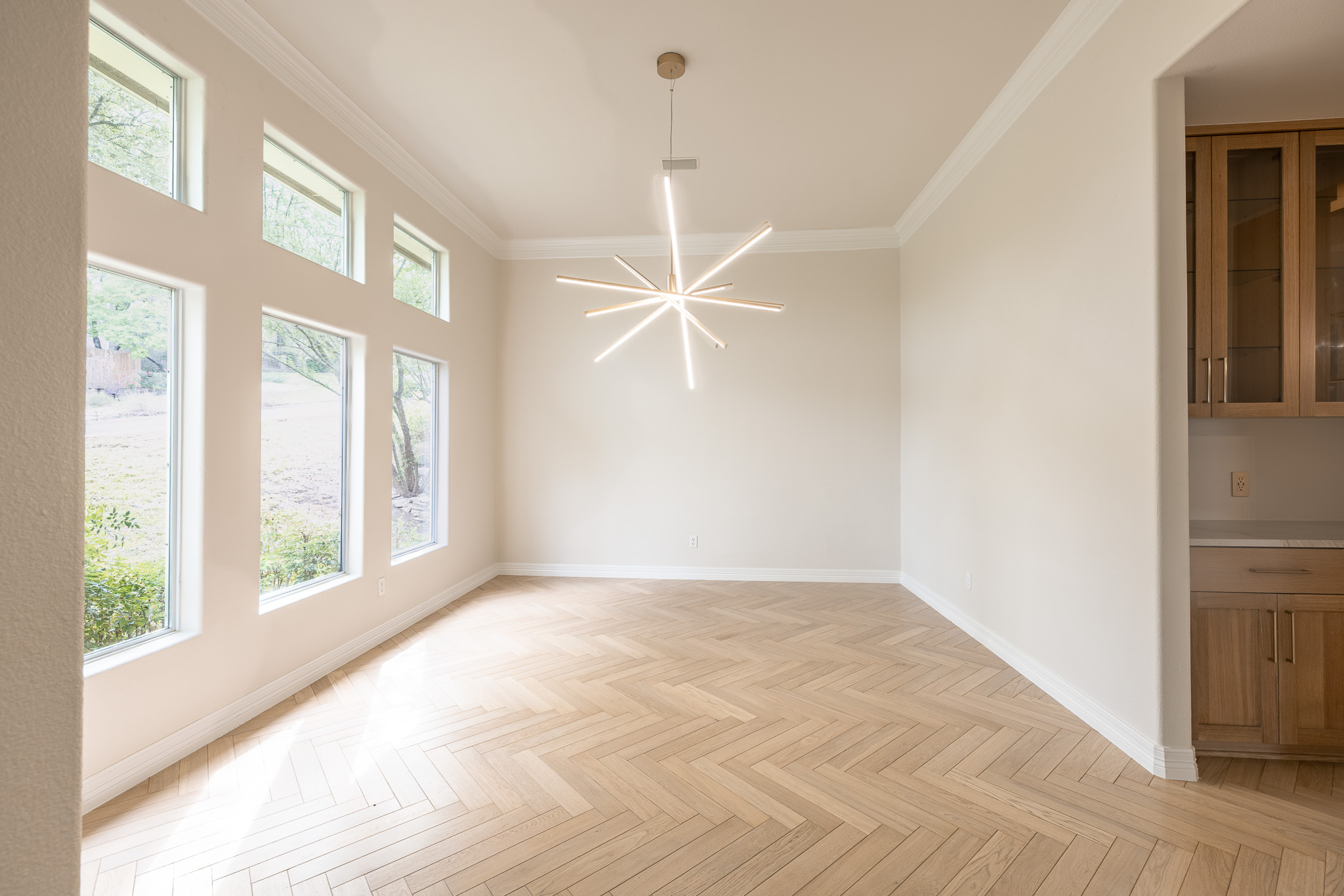 2906 Mill Reef Cove Austin, TX 78746 - Photo 9 of 38 a view of an empty room with a window and wooden floor