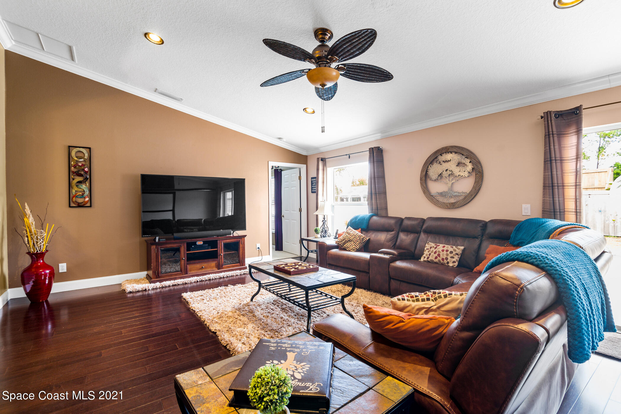 6336 Hudson Road Cocoa, FL 32927 - Photo 12 of 24 a living room with furniture a rug and a flat screen tv