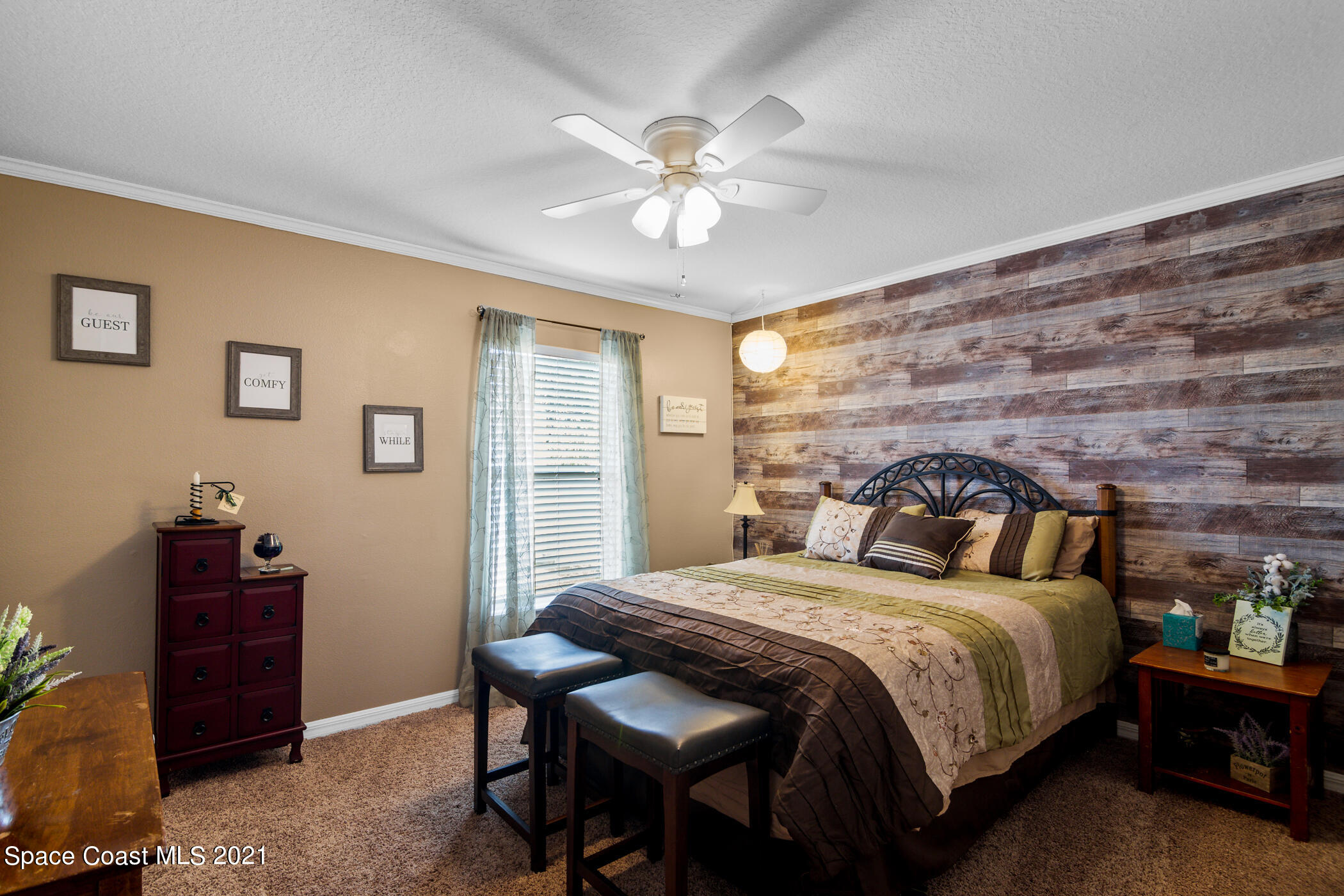 6336 Hudson Road Cocoa, FL 32927 - Photo 16 of 24 a bedroom with a bed and a chandelier