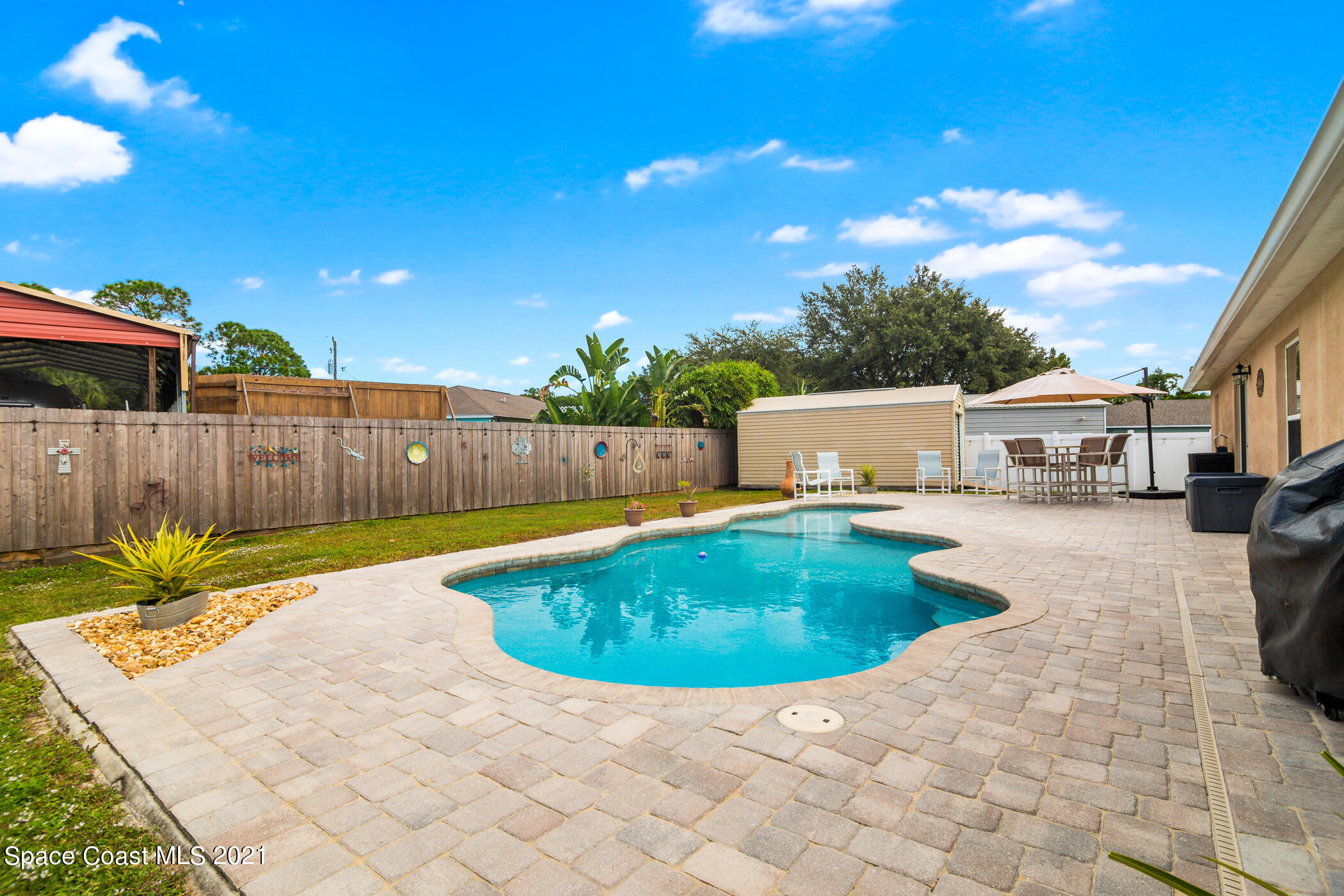 6336 Hudson Road Cocoa, FL 32927 - Photo 20 of 24 a view of a swimming pool with a patio
