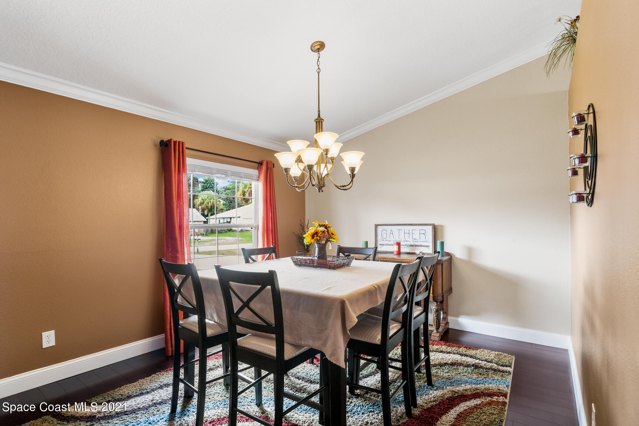 6336 Hudson Road Cocoa, FL 32927 - Photo 2 of 24 a dining room with furniture a chandelier and window