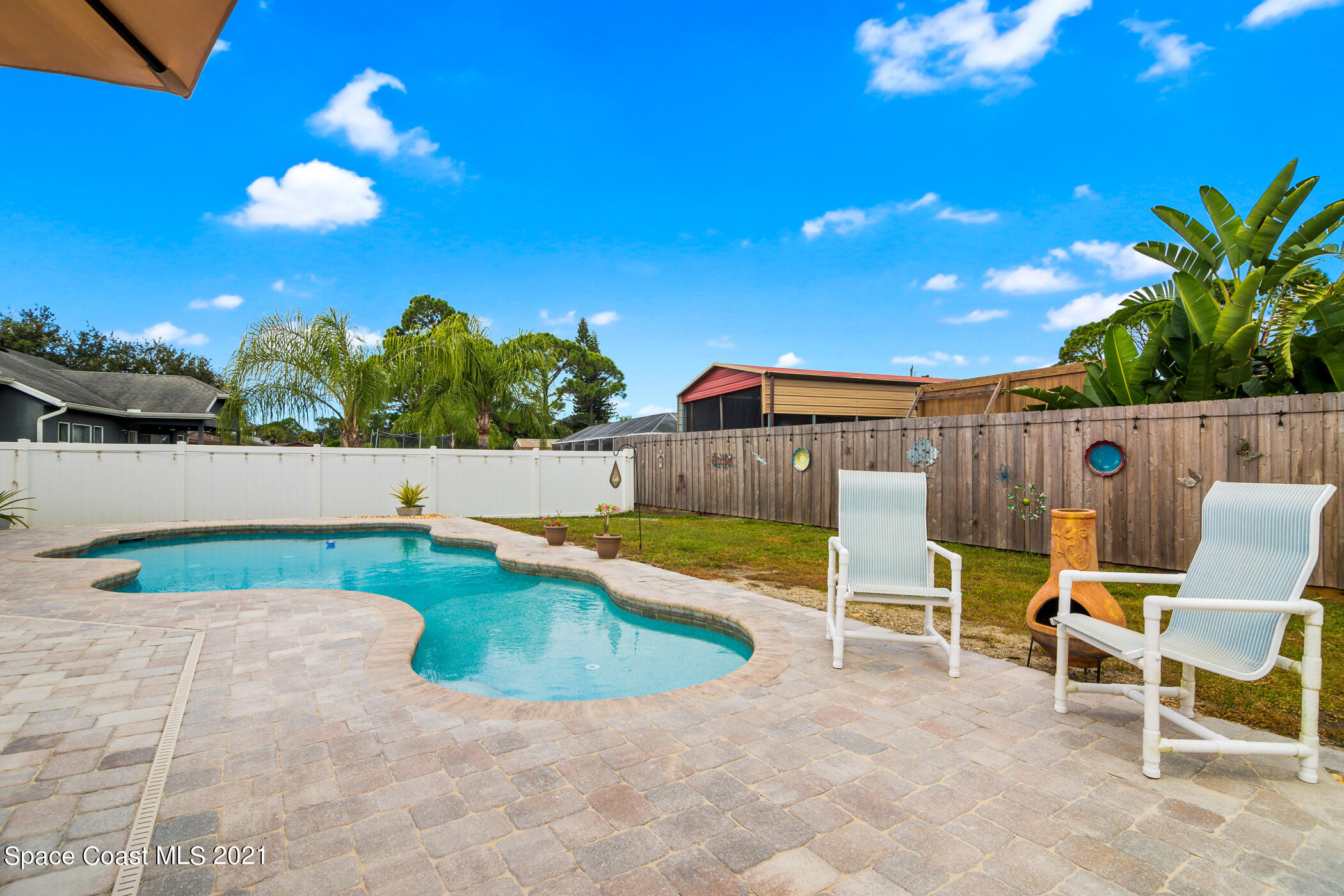 6336 Hudson Road Cocoa, FL 32927 - Photo 21 of 24 a view of a swimming pool with a lounge chairs