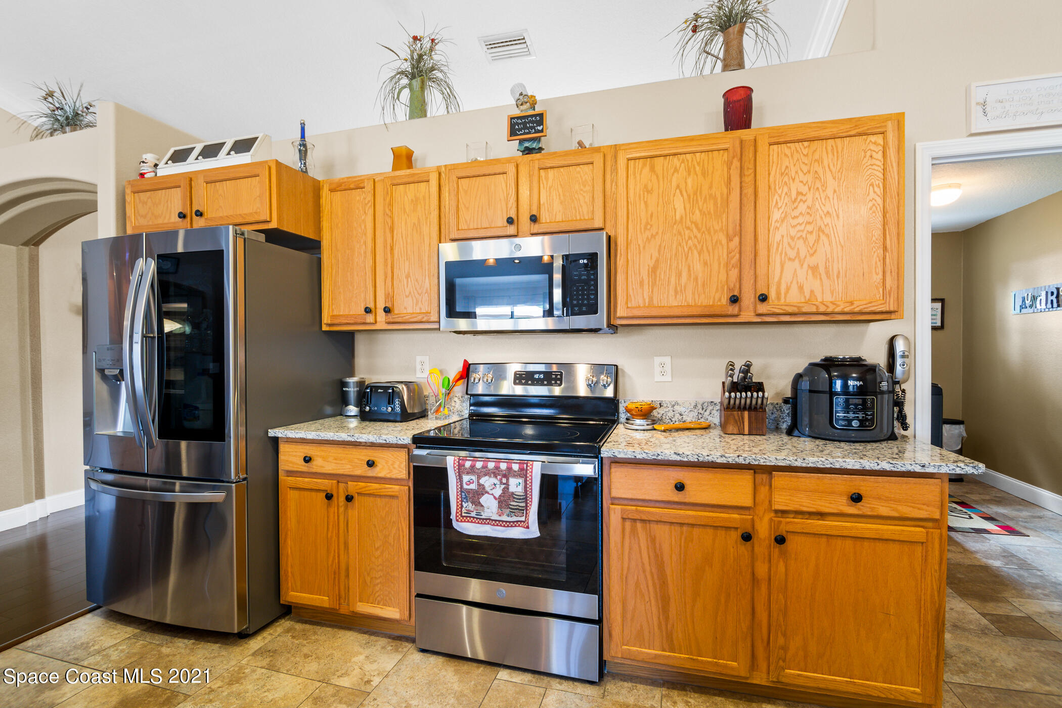 6336 Hudson Road Cocoa, FL 32927 - Photo 5 of 24 a kitchen with stainless steel appliances granite countertop a refrigerator a stove a sink and dishwasher