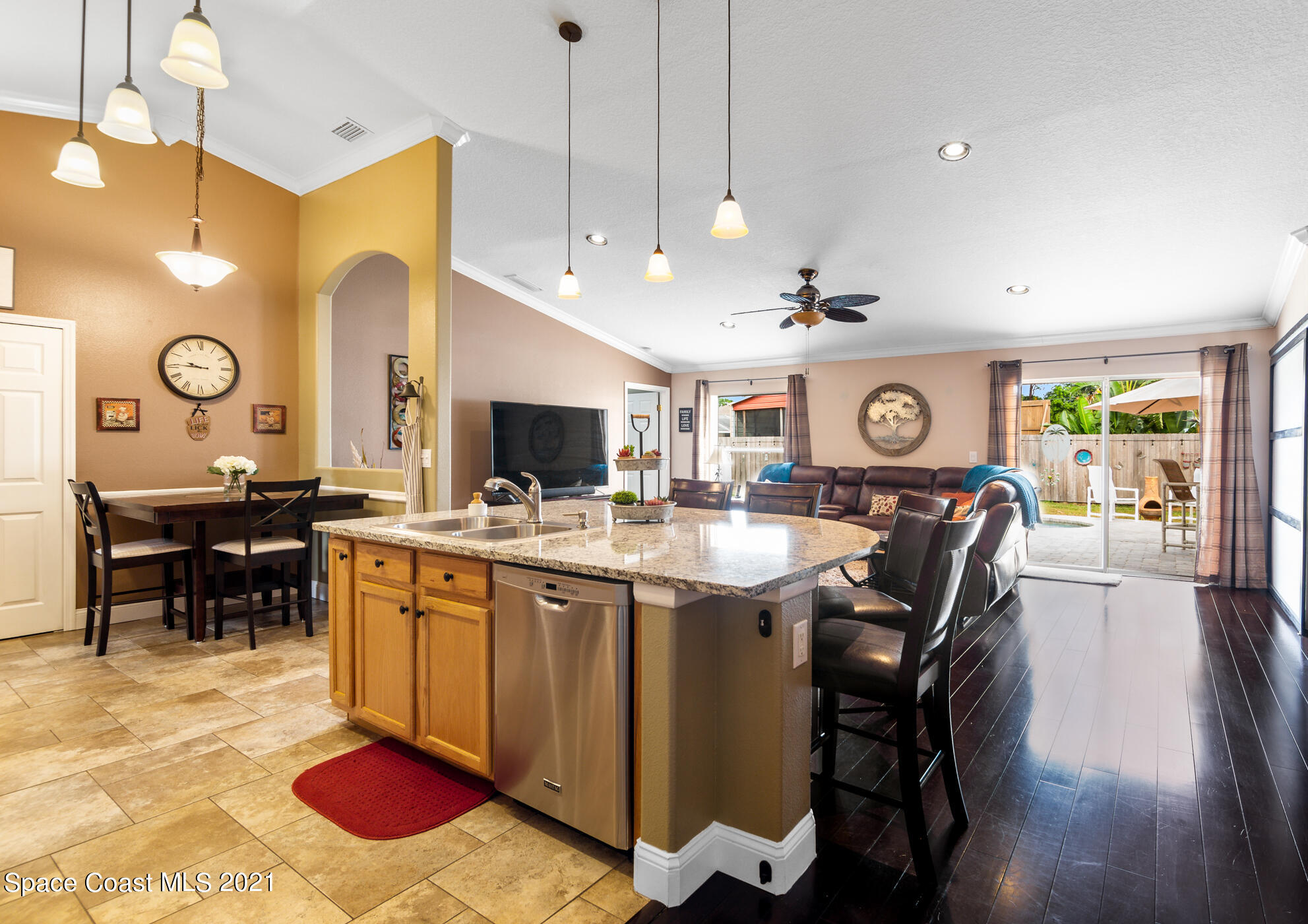 6336 Hudson Road Cocoa, FL 32927 - Photo 8 of 24 a open kitchen with stainless steel appliances granite countertop a sink a stove and a dining table with chairs