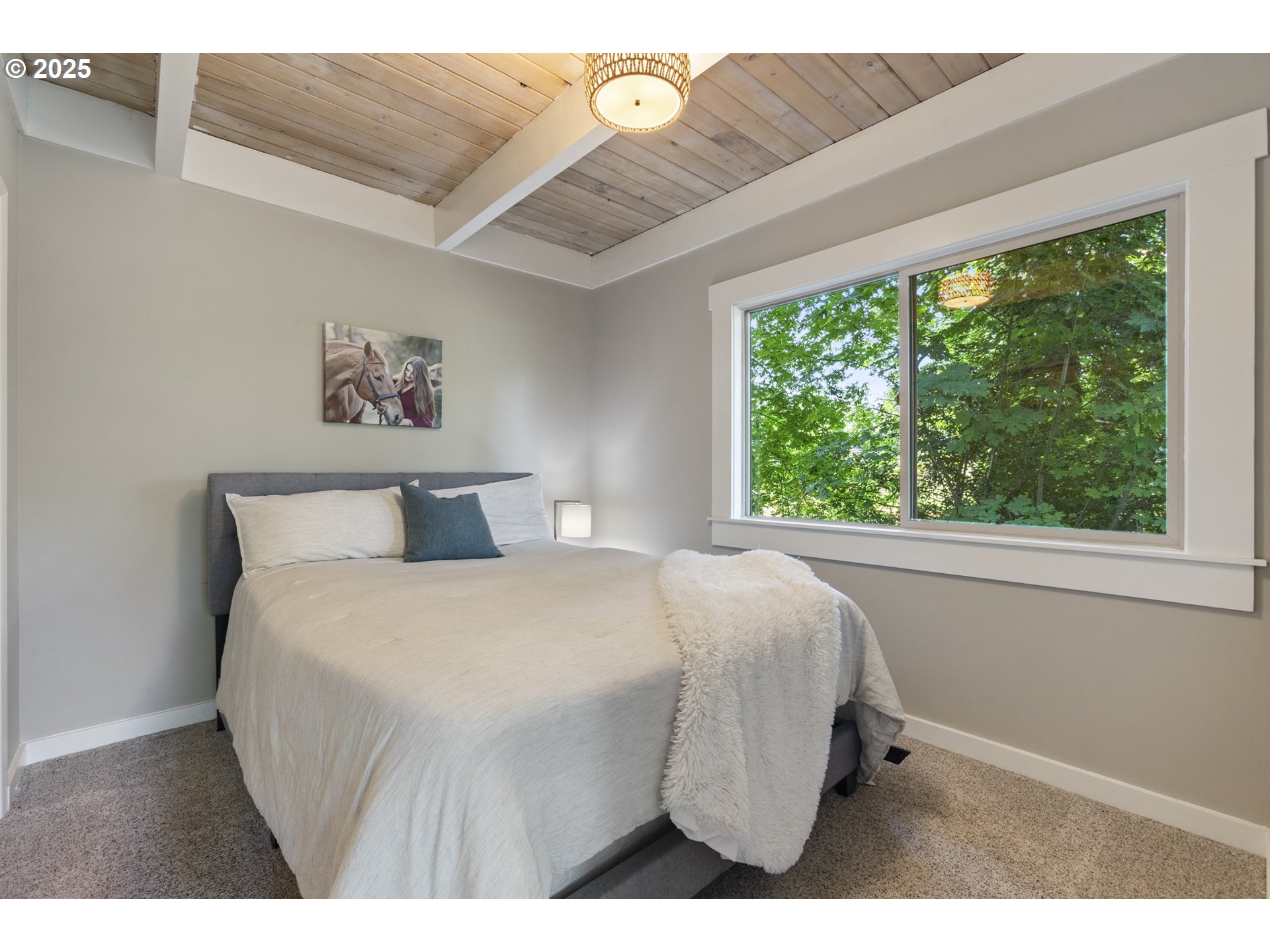28825 Southwest Grahams Ferry Road Wilsonville, OR 97070 - Photo 14 of 36 a bedroom with a bed a painting on the wall and a large window