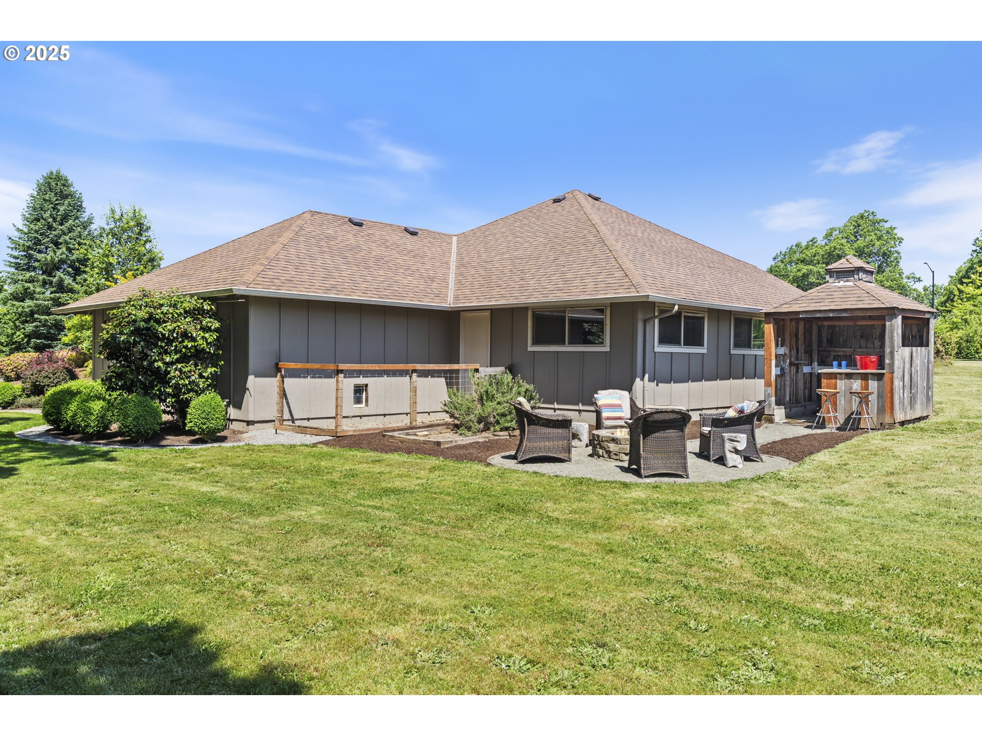 28825 Southwest Grahams Ferry Road Wilsonville, OR 97070 - Photo 31 of 36 a view of a patio with table and chairs under an umbrella