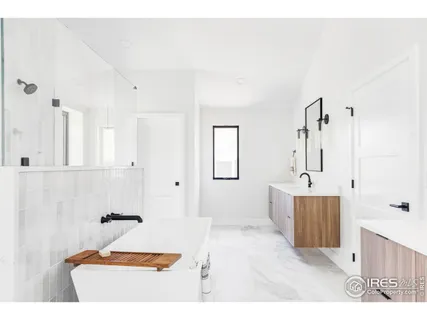 a bathroom with a tub sink and mirror