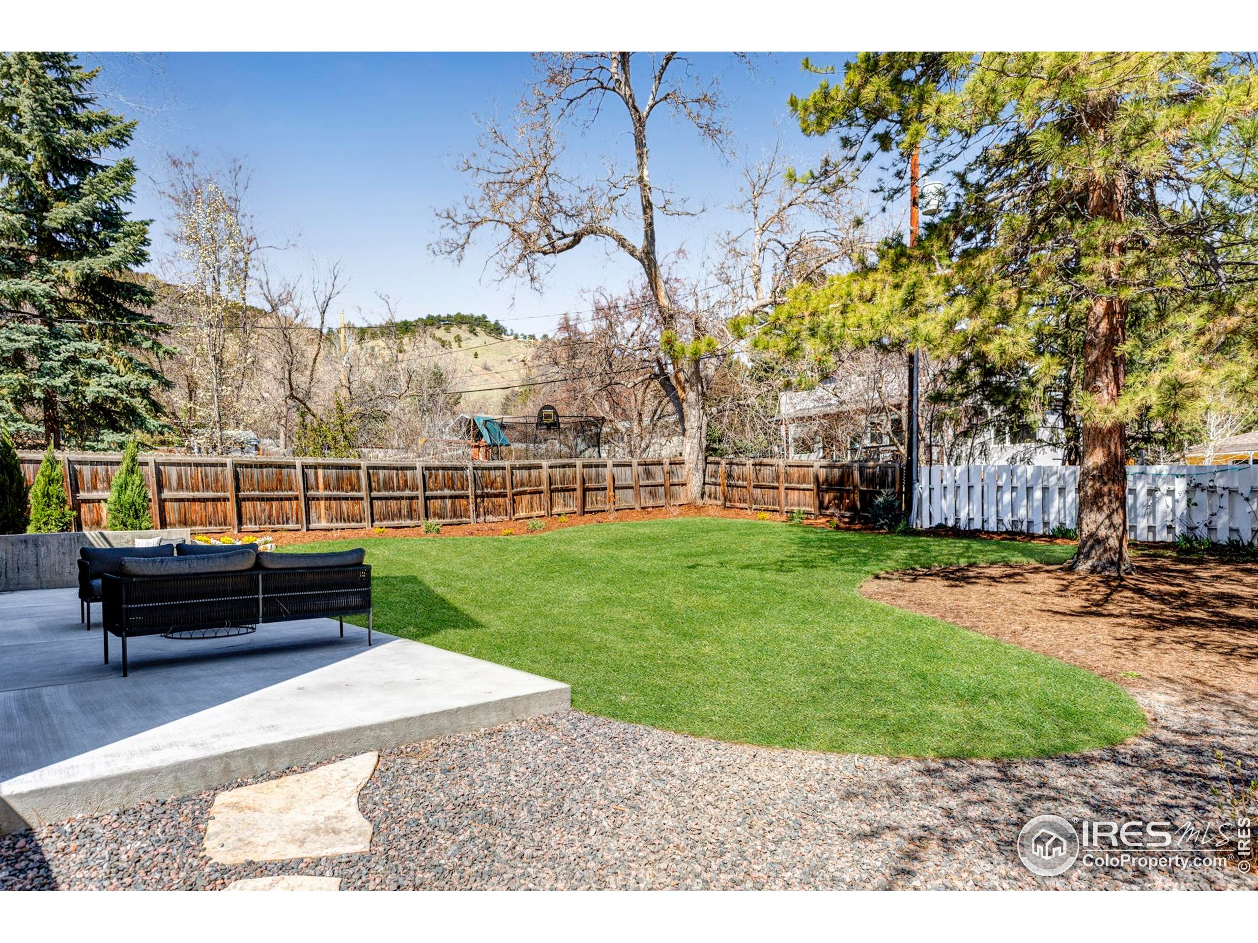 503 Hawthorn Avenue Boulder, CO 80304 - Photo 25 of 27 a view of a garden with a bench in the background
