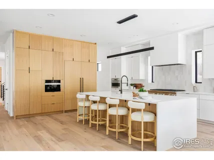 a kitchen with a cabinets and chairs