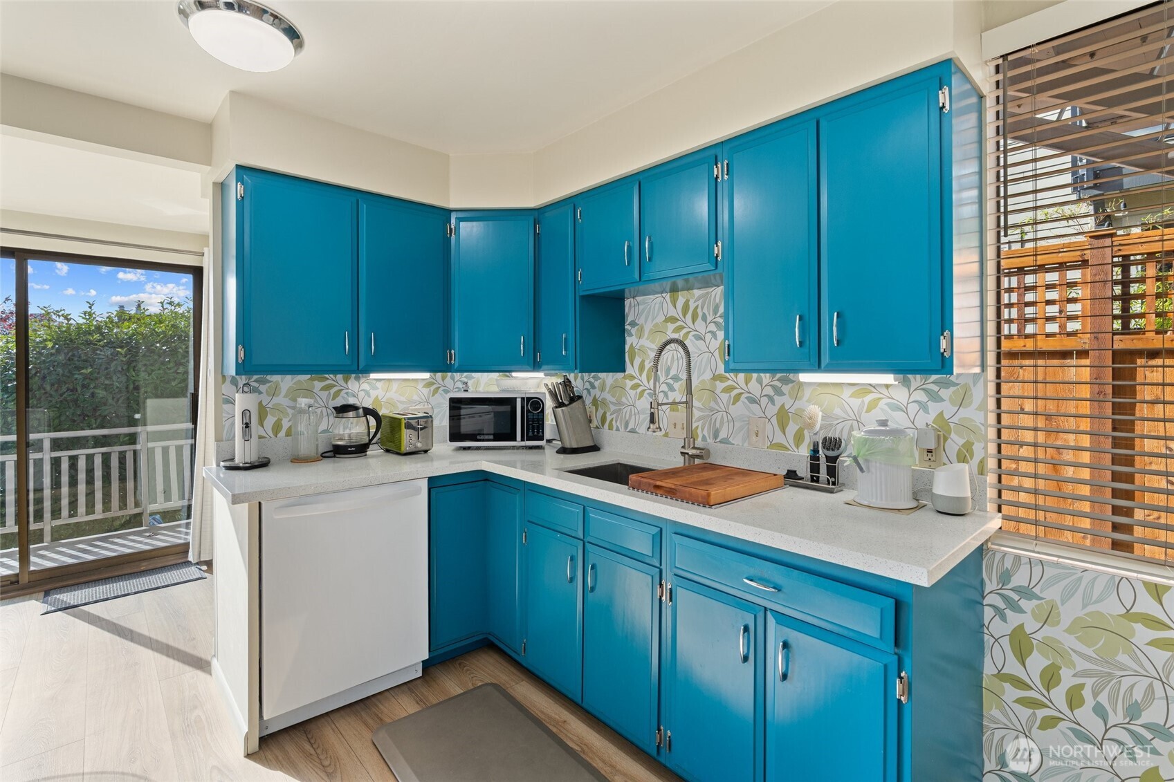 561 Lee Street Seattle, WA 98109 - Photo 12 of 40 a kitchen with a sink a stove and cabinets
