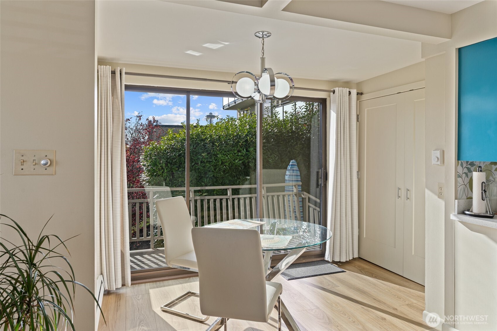 561 Lee Street Seattle, WA 98109 - Photo 16 of 40 a view of a dining room with furniture wooden floor and chandelier