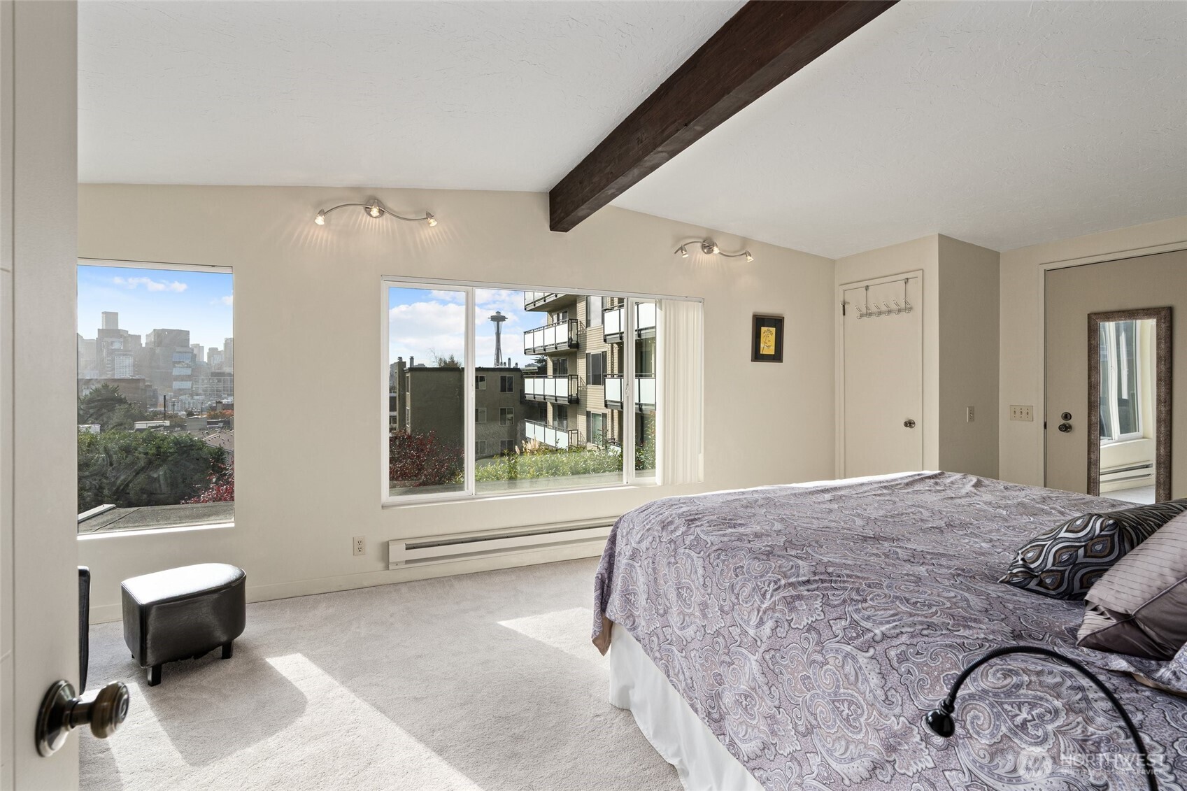 561 Lee Street Seattle, WA 98109 - Photo 21 of 40 a spacious bedroom with a bed a table and large window
