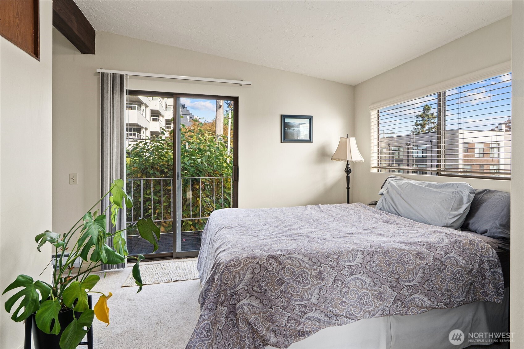 561 Lee Street Seattle, WA 98109 - Photo 22 of 40 a bed sitting in a bedroom next to a window