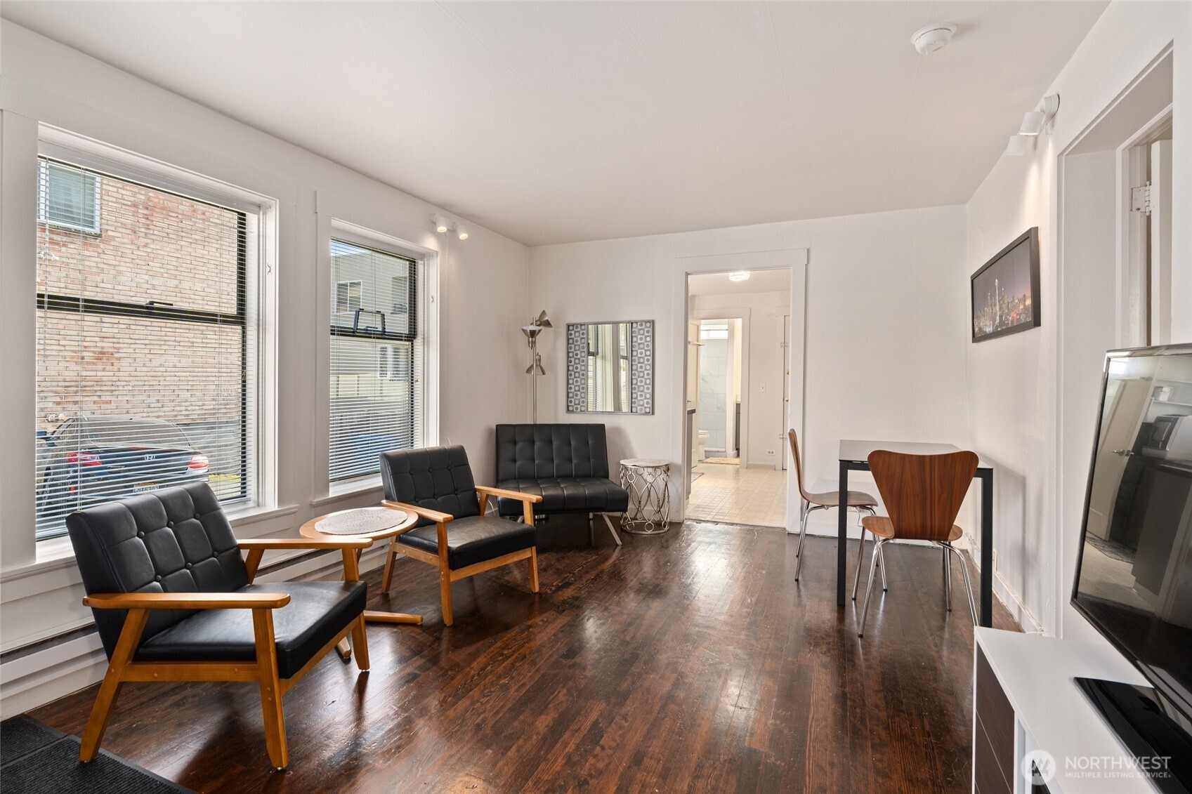 561 Lee Street Seattle, WA 98109 - Photo 29 of 40 a living room with furniture and a flat screen tv