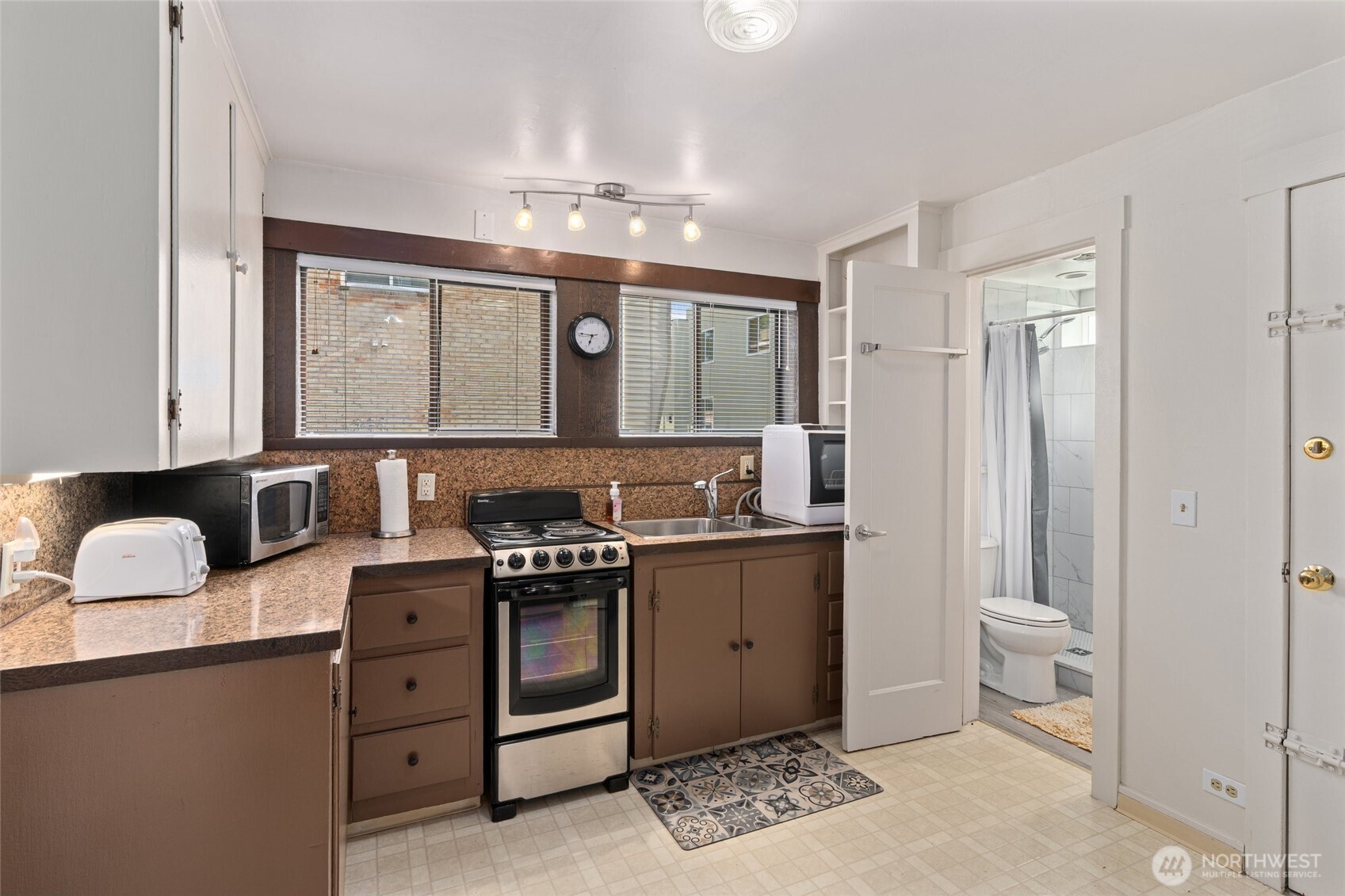 561 Lee Street Seattle, WA 98109 - Photo 31 of 40 a kitchen with a sink stove and cabinets