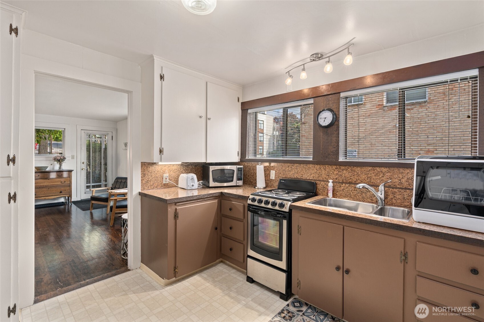 561 Lee Street Seattle, WA 98109 - Photo 32 of 40 a kitchen with a sink stove and cabinets