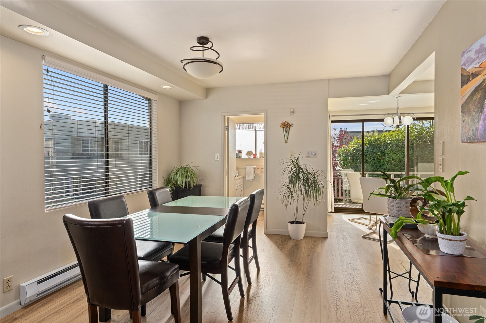 561 Lee Street Seattle, WA 98109 - Photo 8 of 40 a dining room with furniture potted plants and wooden floor