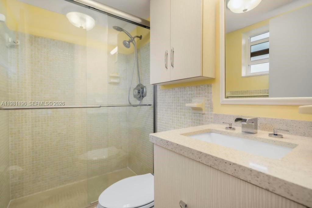 901 South Surf Road, Unit 408 Hollywood, FL 33019 - Photo 11 of 52 a bathroom with a sink a toilet and shower