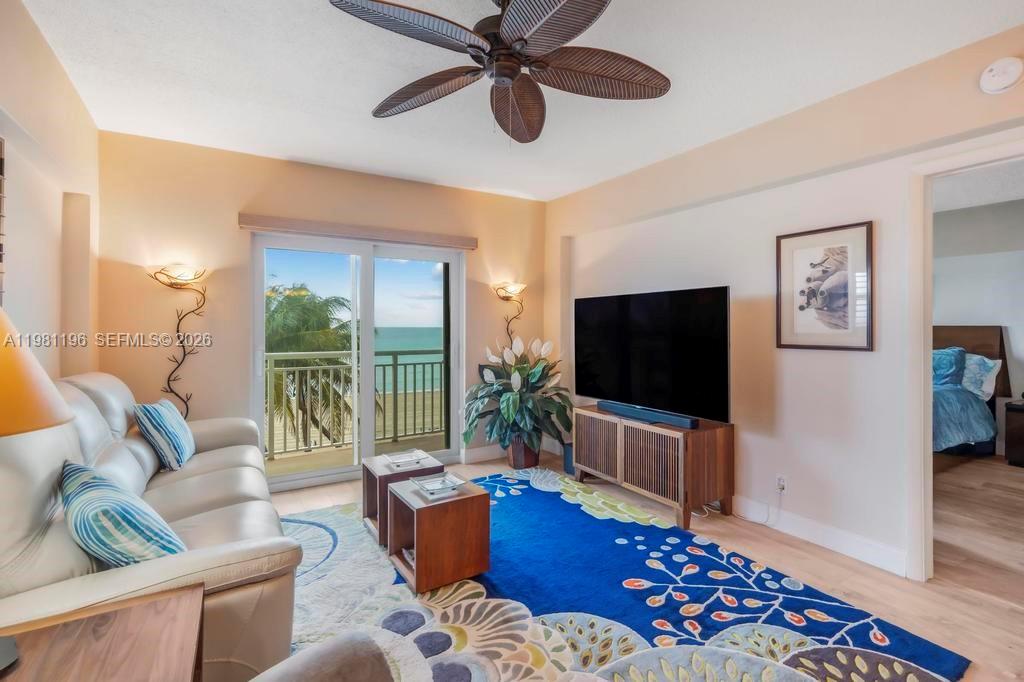901 South Surf Road, Unit 408 Hollywood, FL 33019 - Photo 18 of 52 a living room with furniture and a flat screen tv