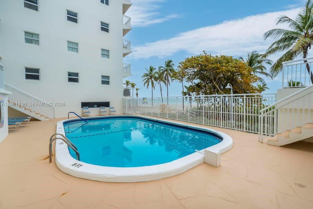 901 South Surf Road, Unit 408 Hollywood, FL 33019 - Photo 30 of 52 a view of a swimming pool with a yard