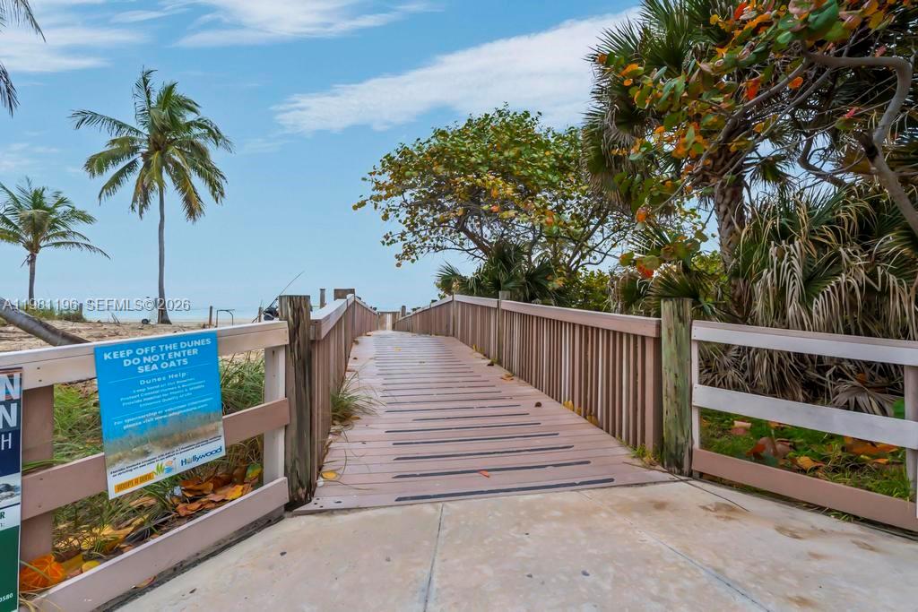 901 South Surf Road, Unit 408 Hollywood, FL 33019 - Photo 36 of 52 a view of a wooden deck with a palm tree
