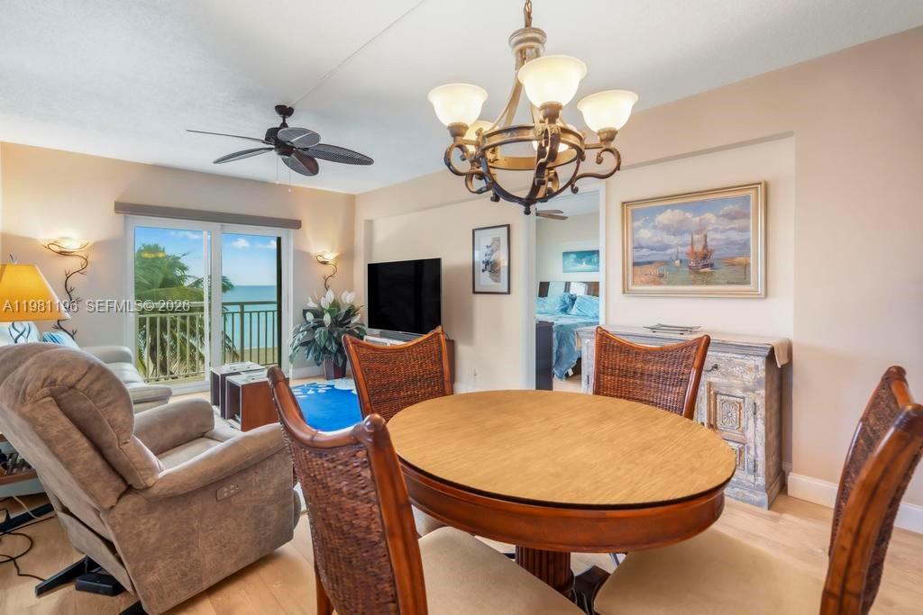 901 South Surf Road, Unit 408 Hollywood, FL 33019 - Photo 5 of 52 a view of a dining room with furniture wooden floor and chandelier