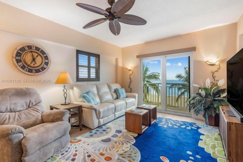 901 South Surf Road, Unit 408 Hollywood, FL 33019 - Photo 6 of 52 a living room with furniture and a flat screen tv