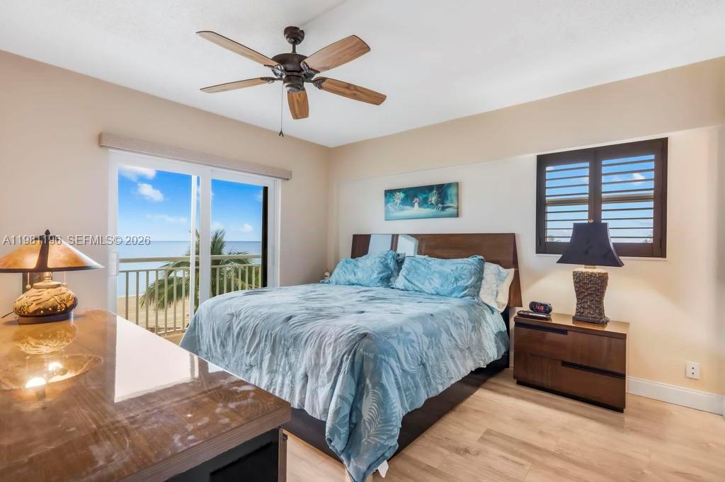 901 South Surf Road, Unit 408 Hollywood, FL 33019 - Photo 7 of 52 a bedroom with a bed and wooden floor