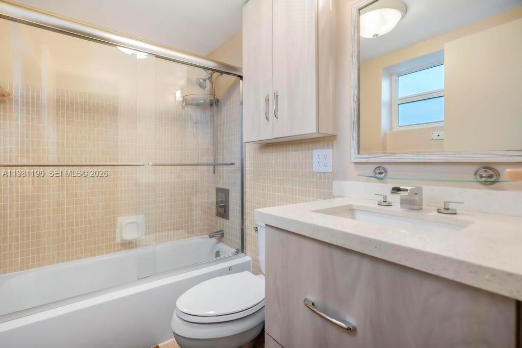 901 South Surf Road, Unit 408 Hollywood, FL 33019 - Photo 9 of 52 a bathroom with a granite countertop sink toilet and shower