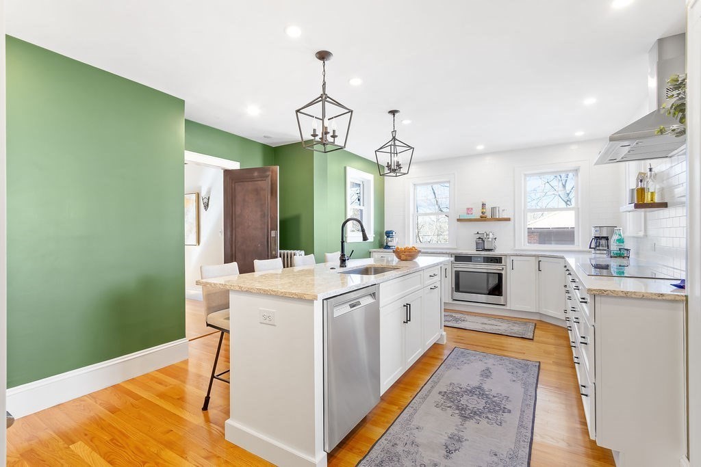 75 Longfellow Road Worcester, MA 01602 - Photo 14 of 37 a kitchen that has a lot of white cabinets and stainless steel appliances