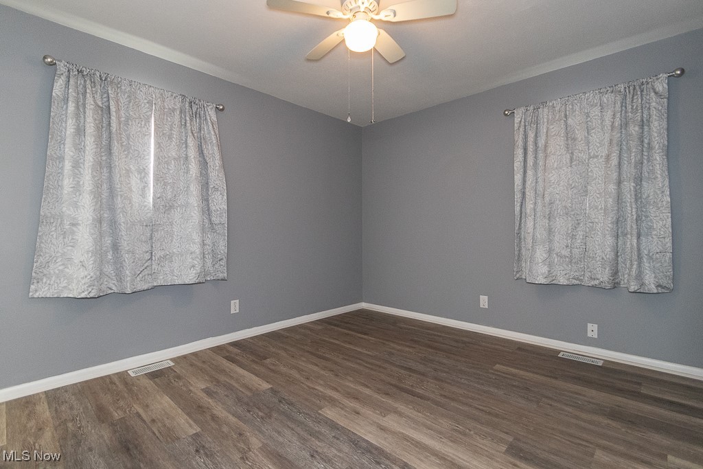 7996 Munson Road Mentor, OH 44060 - Photo 20 of 33 Empty room with dark hardwood / wood-style flooring and ceiling fan