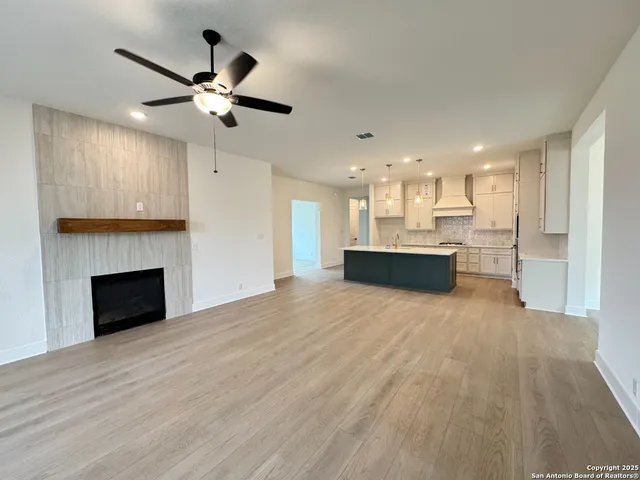 a view of a kitchen with a sink and a fireplace
