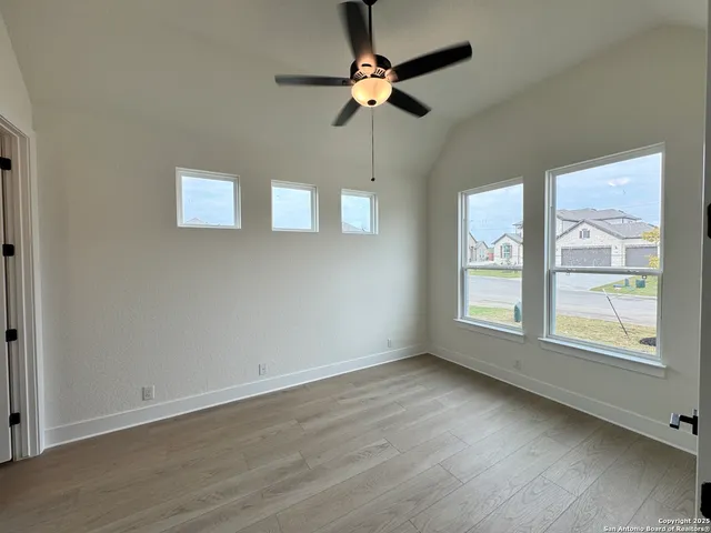 a large kitchen with kitchen island a sink a stove and a wooden floors
