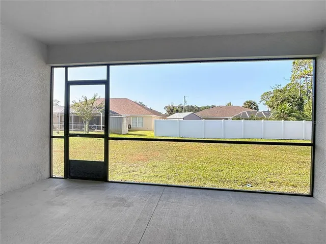 a large kitchen with granite countertop a sink cabinets and stainless steel appliances