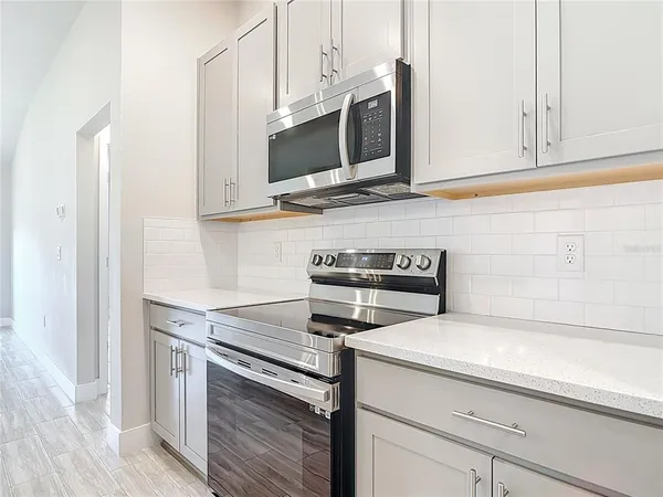 a kitchen with stainless steel appliances white cabinets and a sink