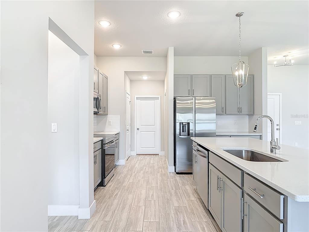 60 Ballenger Lane Palm Coast, FL 32137 - Photo 19 of 60 a kitchen with a sink a counter top space stainless steel appliances and cabinets