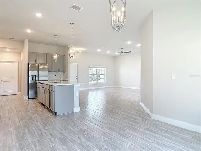a view of an empty room with wooden floor and closet