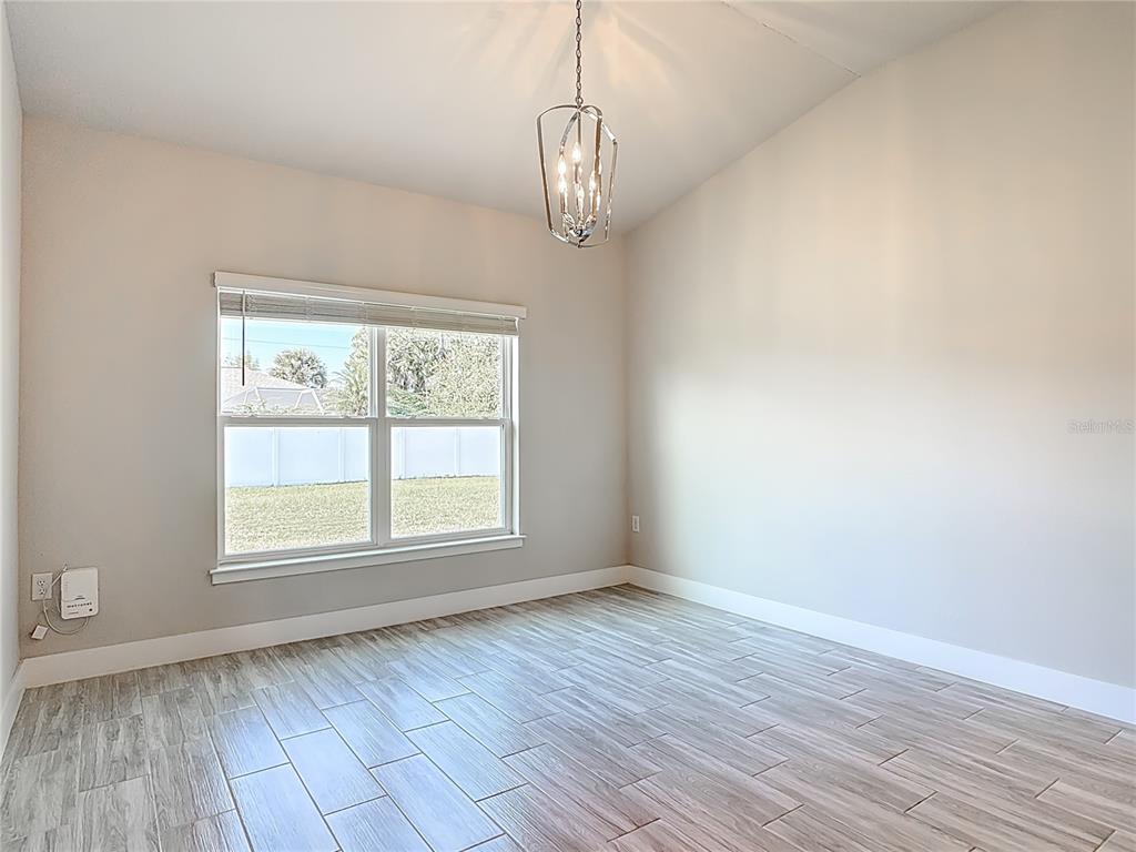 60 Ballenger Lane Palm Coast, FL 32137 - Photo 22 of 60 a view of an empty room with wooden floor and a window
