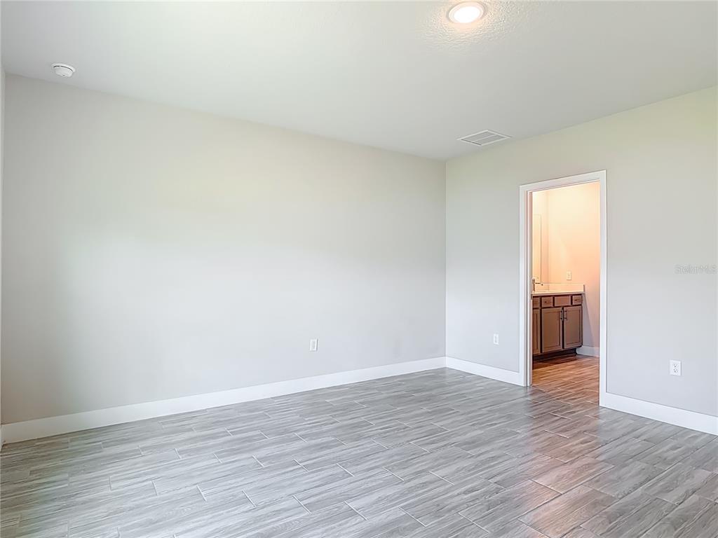 60 Ballenger Lane Palm Coast, FL 32137 - Photo 25 of 60 a view of an empty room with wooden floor