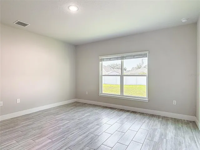 a view of an empty room and wooden floor
