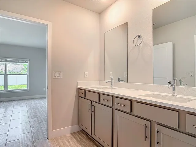 a view of an empty room with wooden floor and closet