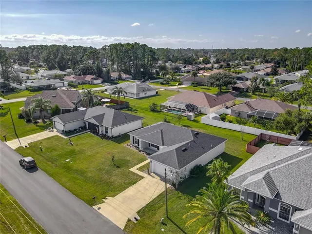 a view of an empty room with kitchen appliances and a window