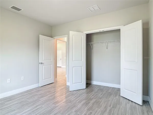 a view of an empty room and wooden floor