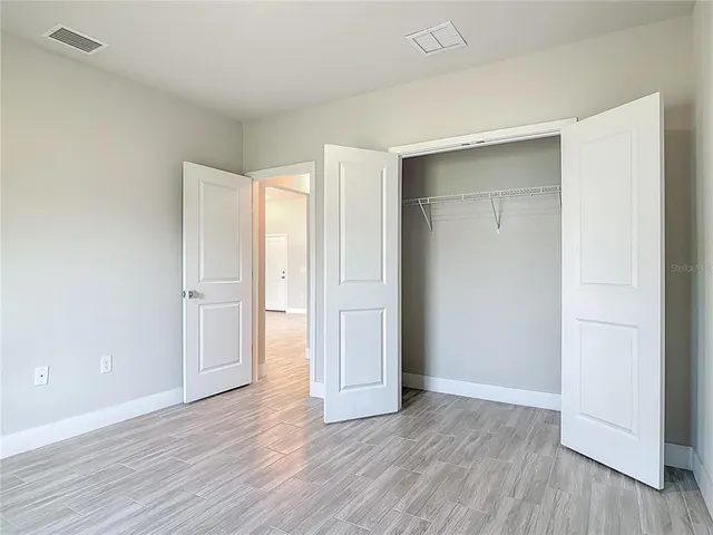 a view of an empty room and wooden floor