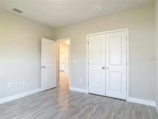 an empty room with large windows