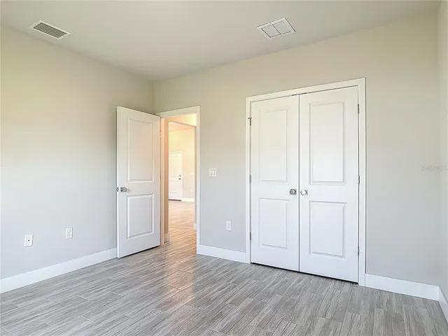 an empty room with large windows