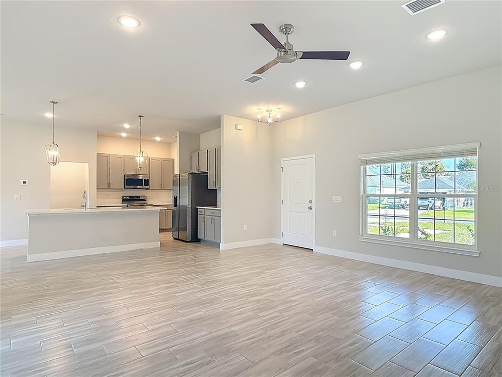 60 Ballenger Lane Palm Coast, FL 32137 - Photo 4 of 60 a view of an empty room with kitchen appliances and a window