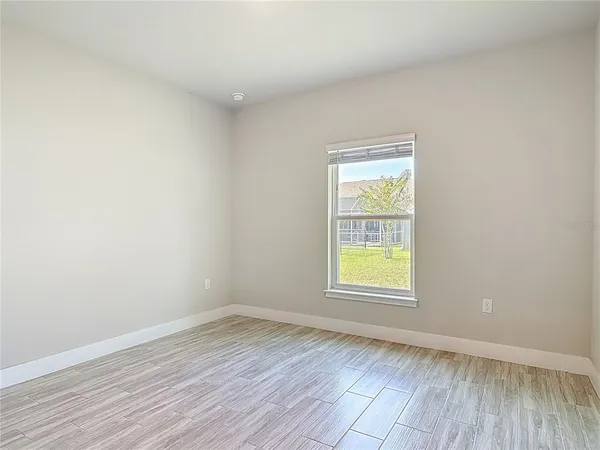 a view of a big room with closet and windows